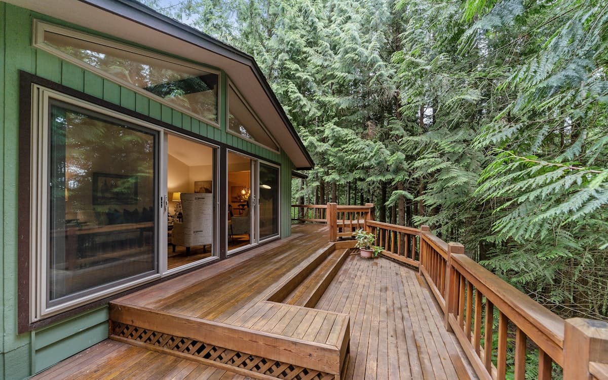 A finished wooden deck off the back of a house