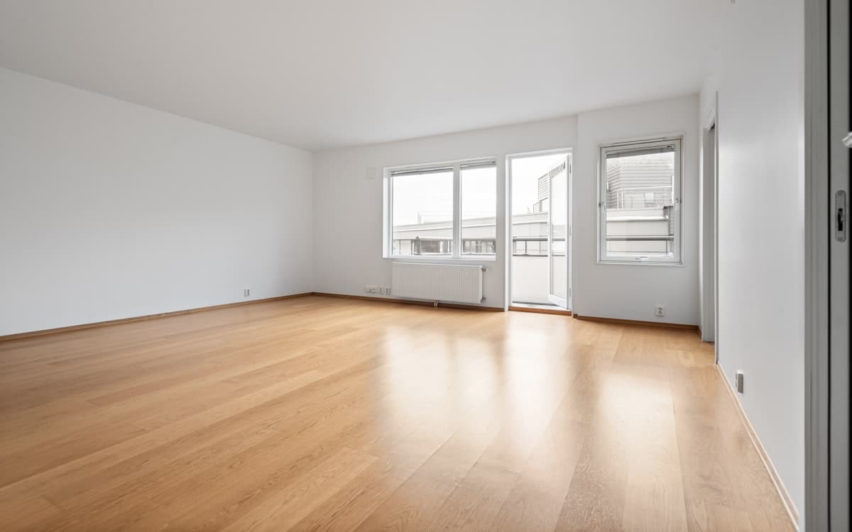 A room with newly installed wide-plank wood flooring